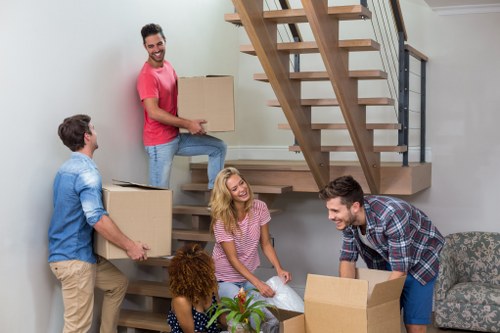 Removal van and moving team working in a Hampstead residential street