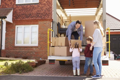 Loading household boxes into a van for a Hampstead move