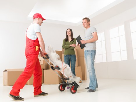 Professional movers handling furniture protection and loading for a Hampstead home